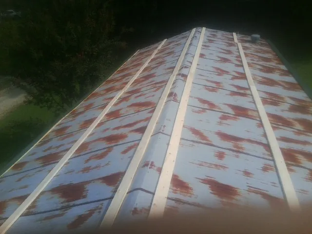 Rusted metal roof panels with new wood purlins before replacement — Storm Damage Roof Repair in Gallipolis by Roofing Brothers