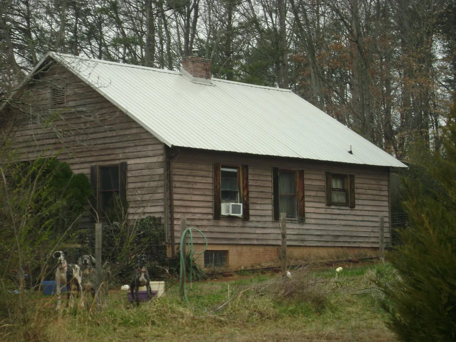 White metal roof on an old wood sided farmhouse, from a Asphalt Shingle Roof Repair job in Gallipolis